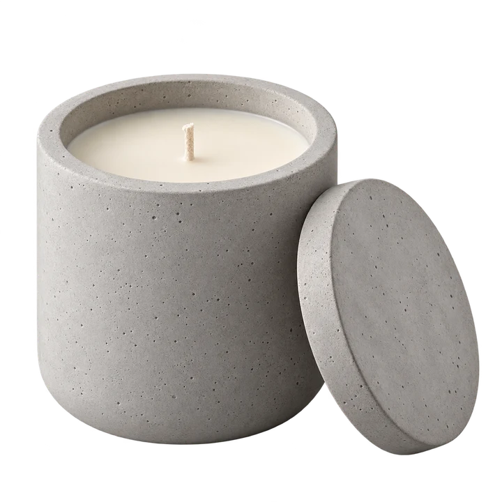 A scented candle in a reusable concrete jar